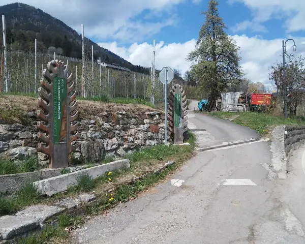 Inizio del sentiero delle fate, con cartelli informativi e un paesaggio montano.