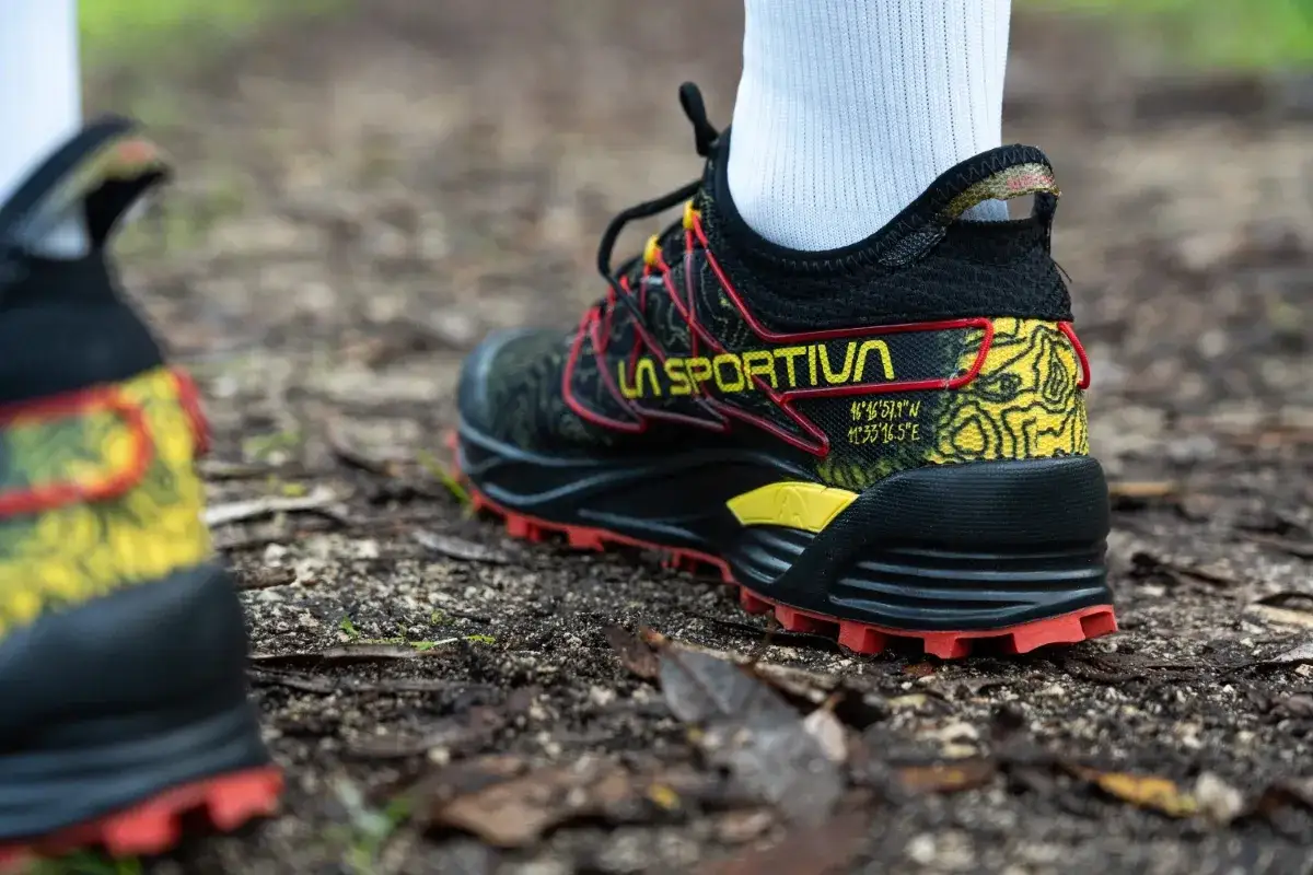 Scarpe da hiking La Sportiva con suola rossa e dettagli gialli, pronte per l'avventura. Il loro significato &egrave; la libert&agrave; di esplorare.